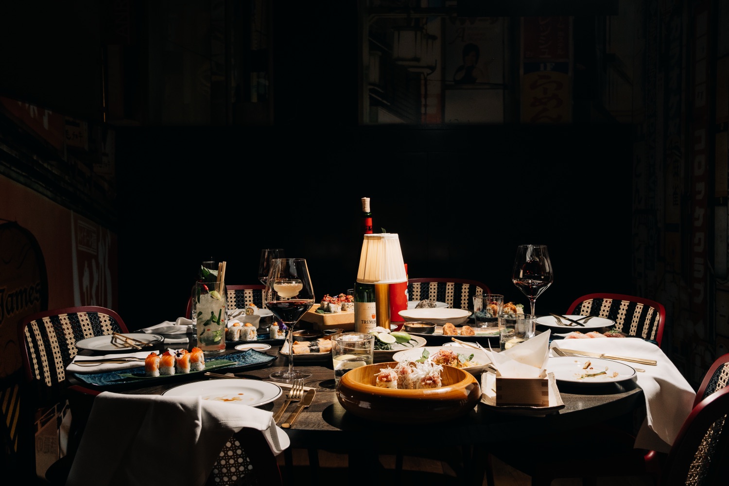 Dinner spread with sushi, wine and candle light
