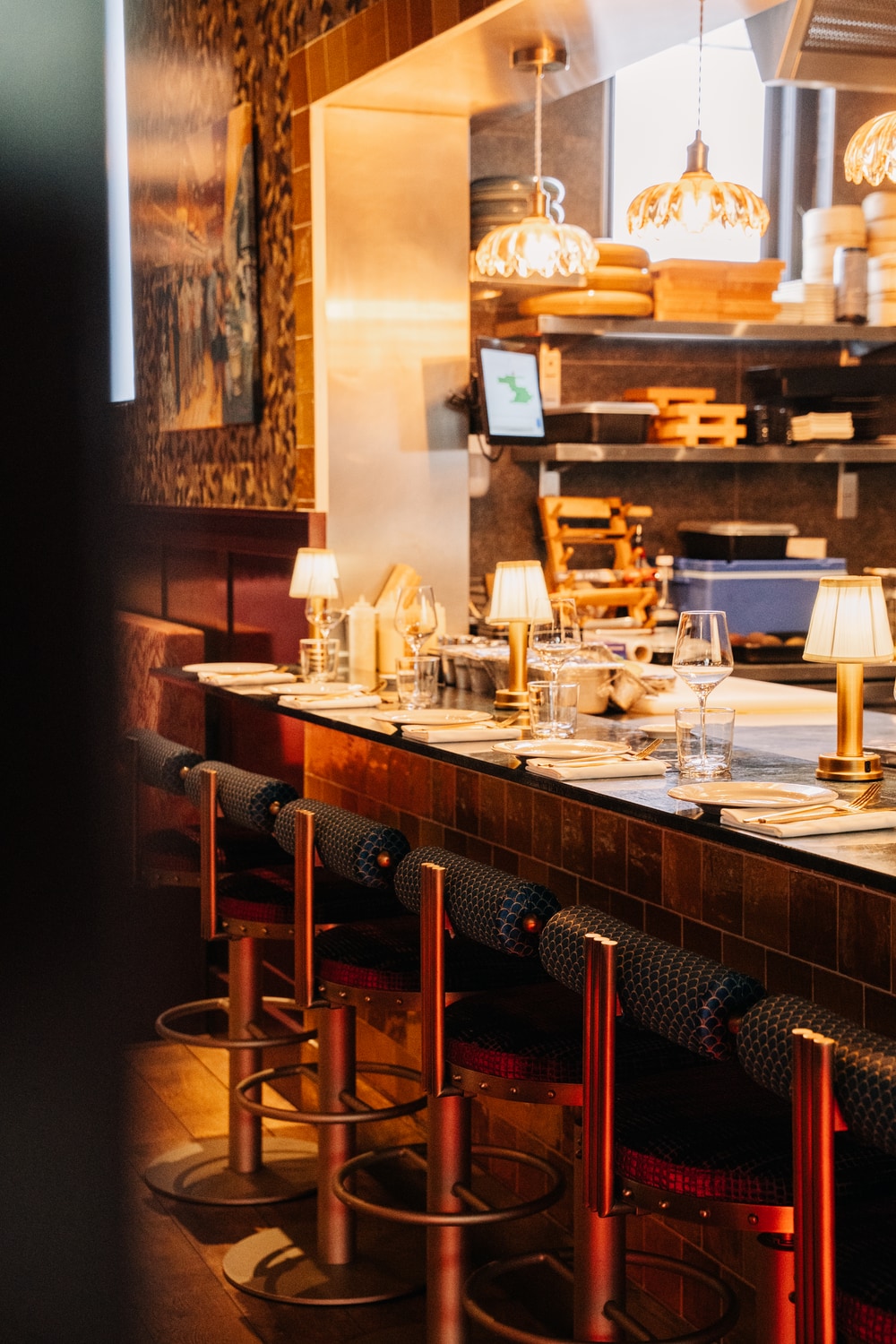 Bar stools at the chef's table counter facing the open kitchen